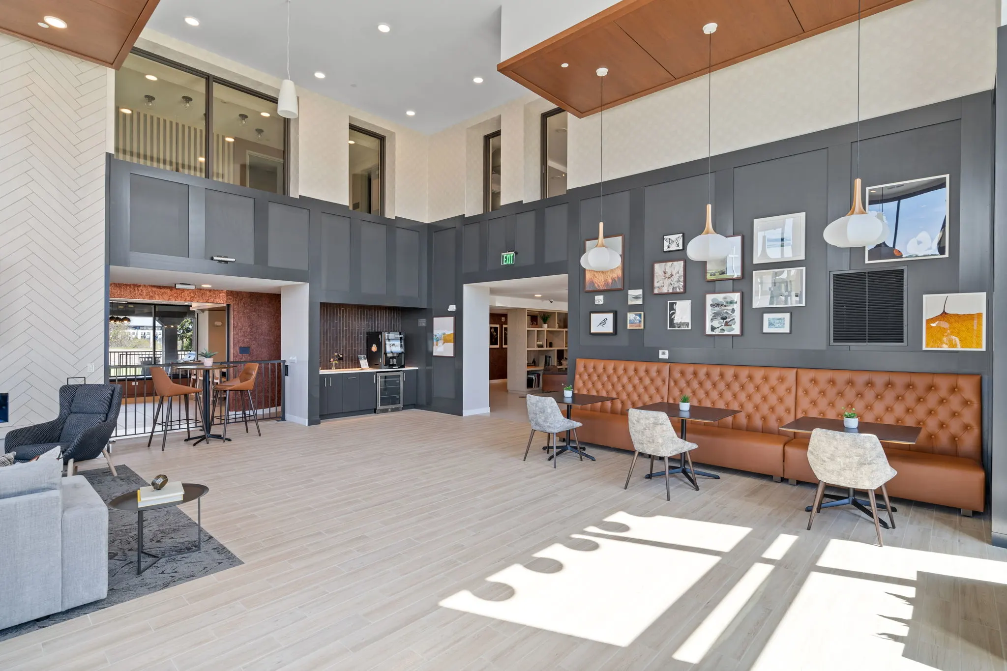 Clubroom seating area at The Townline Apartments with banquette seating, pendant lighting, and modern finishes.