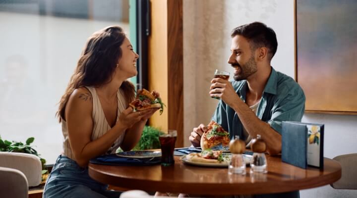 Couple enjoying food and drinks at a local restaurant